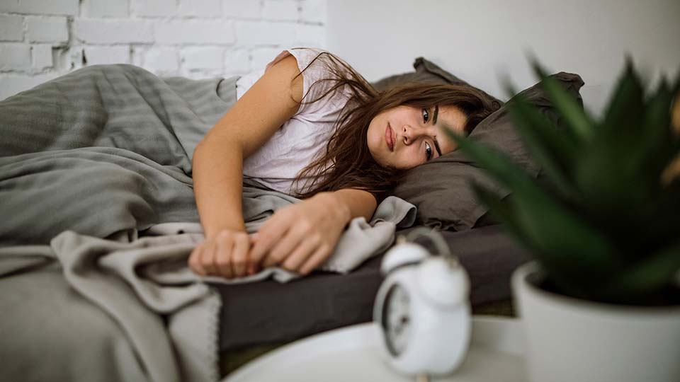Woman struggling to get to sleep