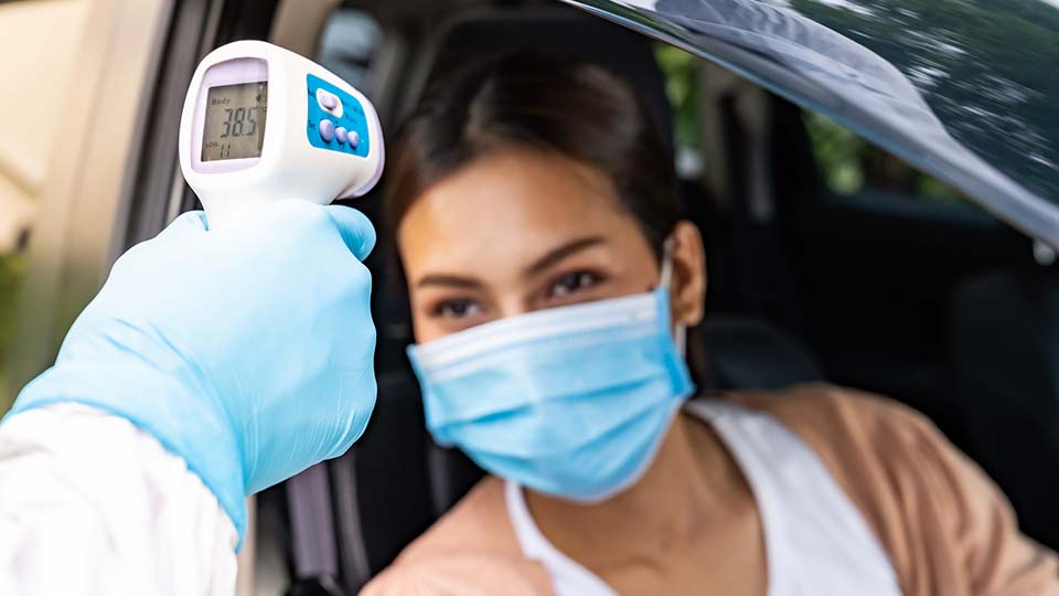 Woman visiting drive-thru COVID testing site.