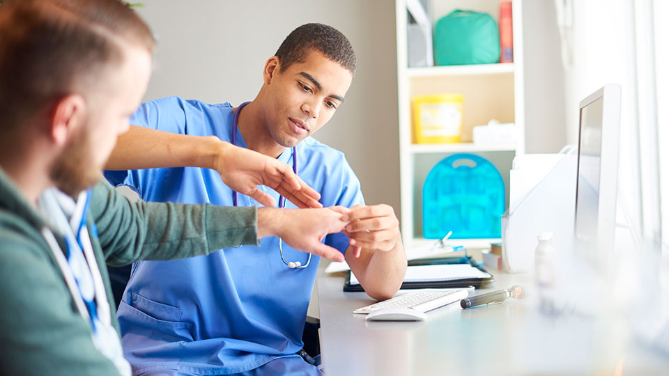 Hand doctor working with patient
