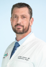 Chad Johnson posing and smiling in a white coat
