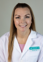Tamara Degenhardt smiling and posing in a white coat