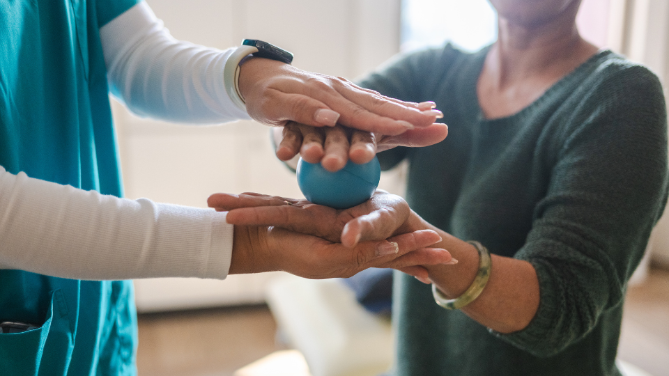 Patient using a compression ball for rehabilitation
