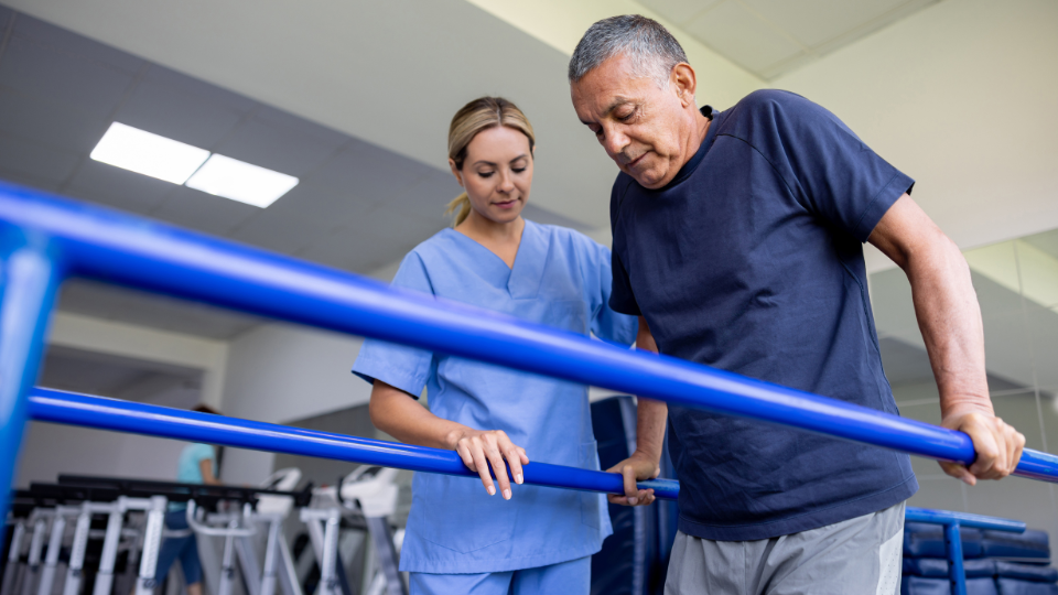A specialist helping a patient walk in rehabilitation and recovery