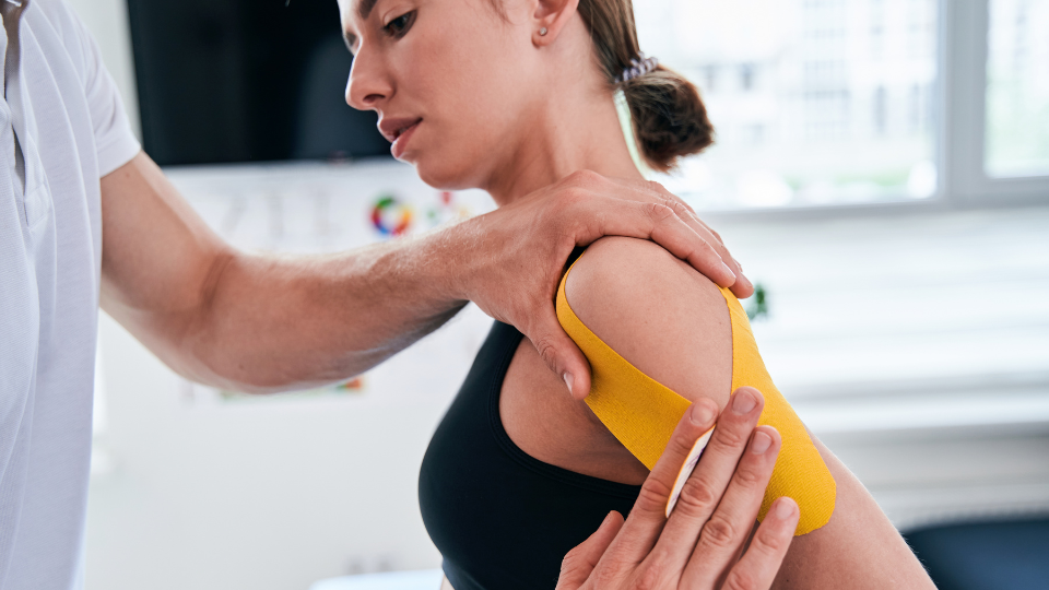 A woman with a taped-up shoulder 