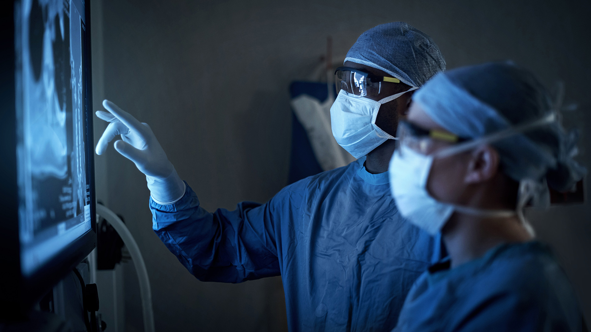 surgeons looking at patient imaging