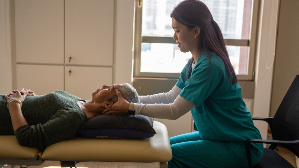 Physical therapist massaging patient's head