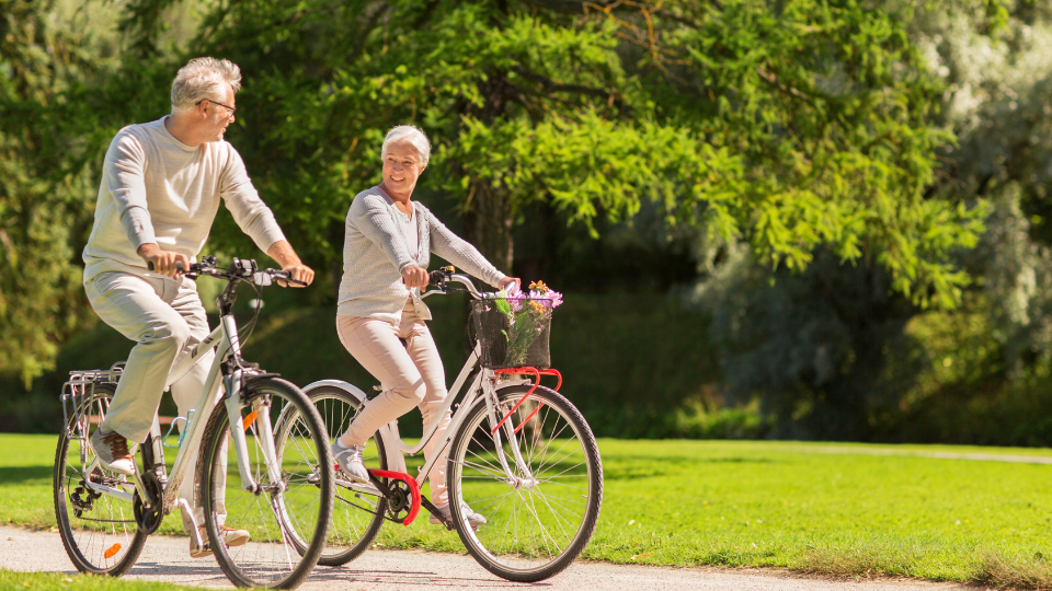 Couple smiling and riding bikes together