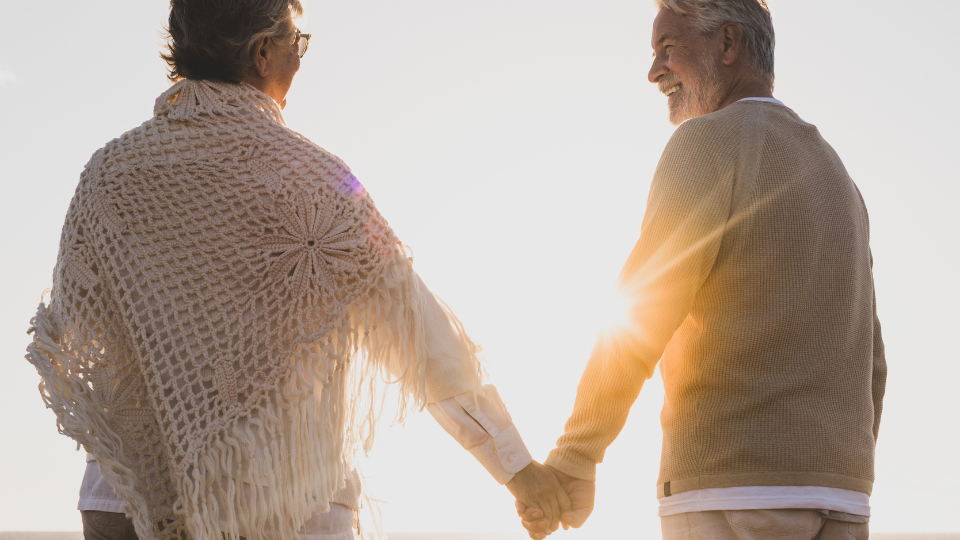 Couple holding hands in the sunset