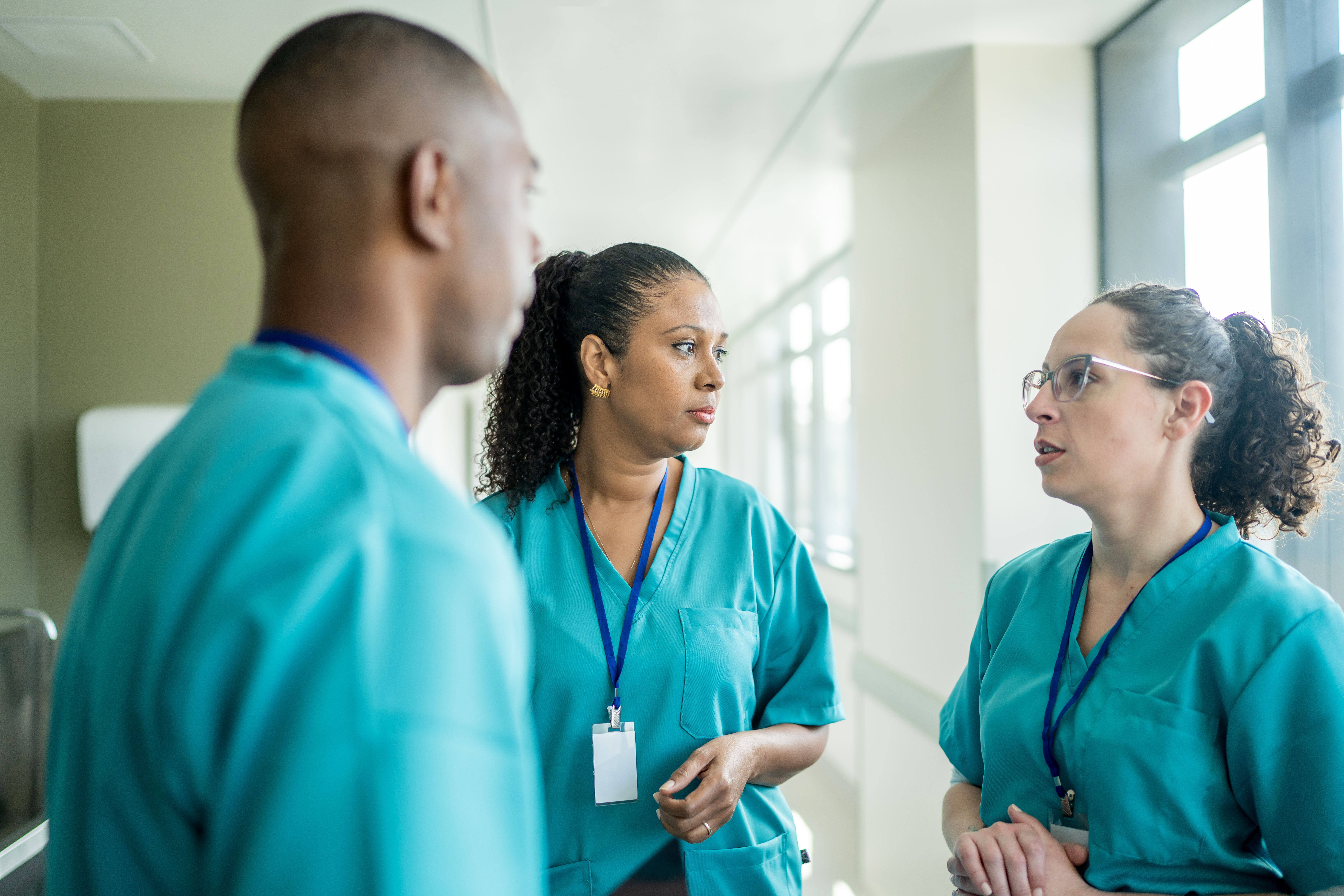 Three trauma nurses in a serious discussion