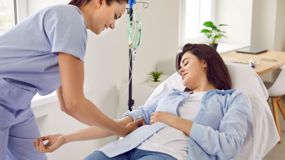 Female patient receiving an infusion by a nurse