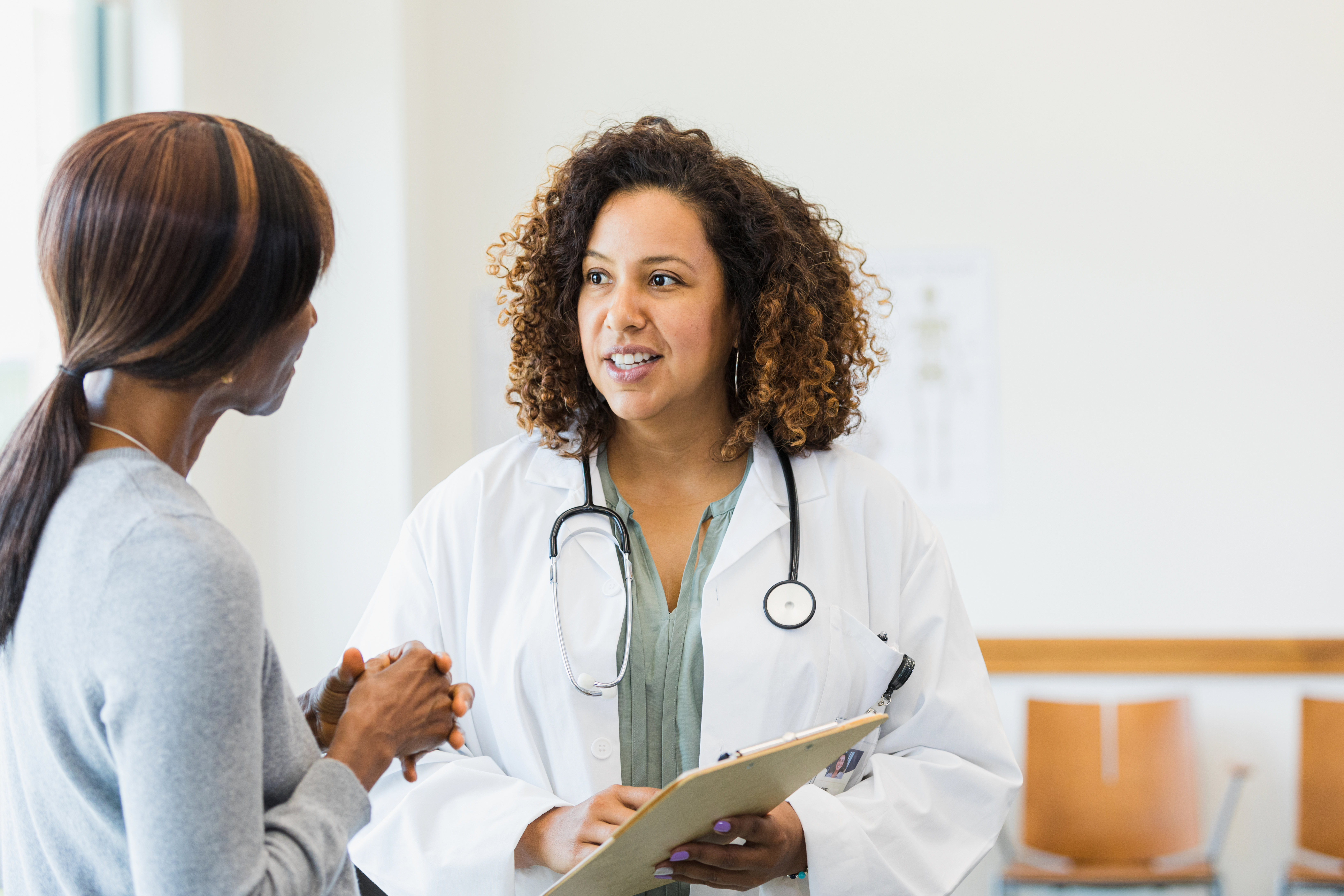 A female doctor talking to a female patient