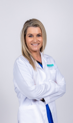 Woman in a physician coat with her hands crossed
