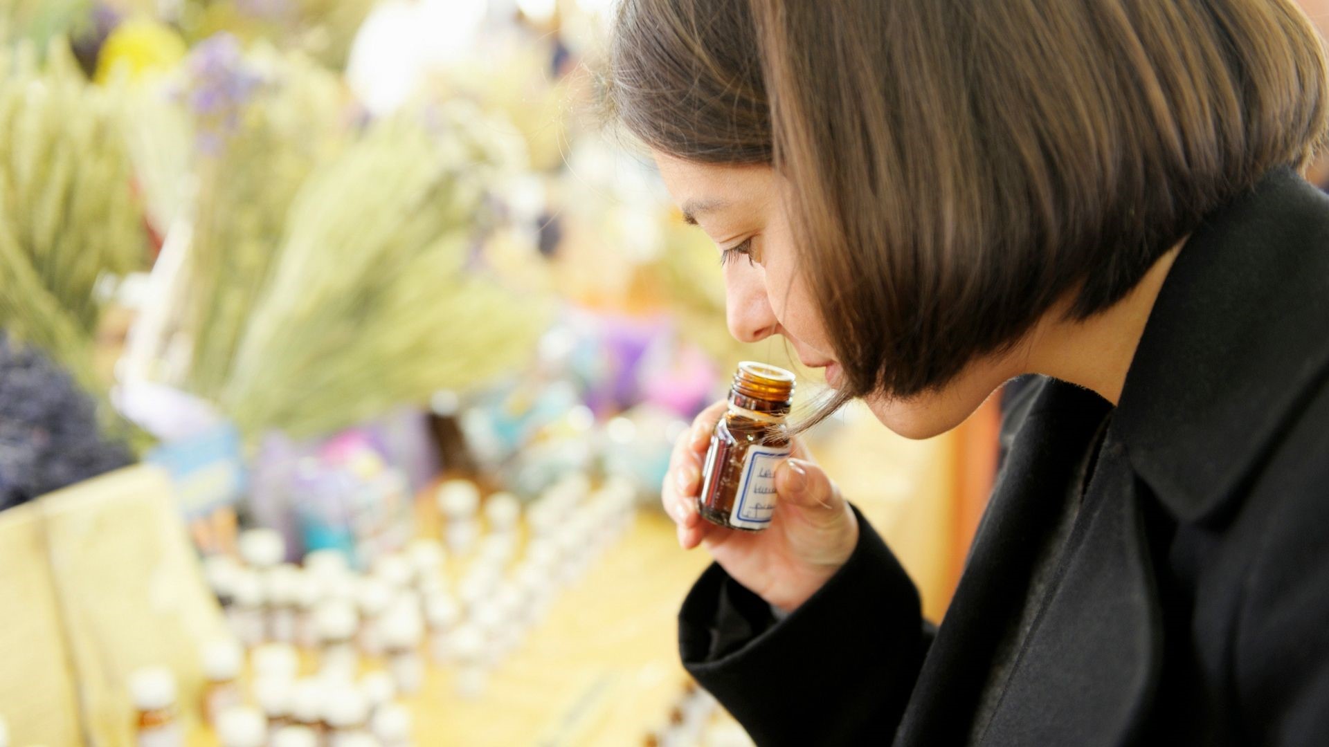 woman smelling essential oil