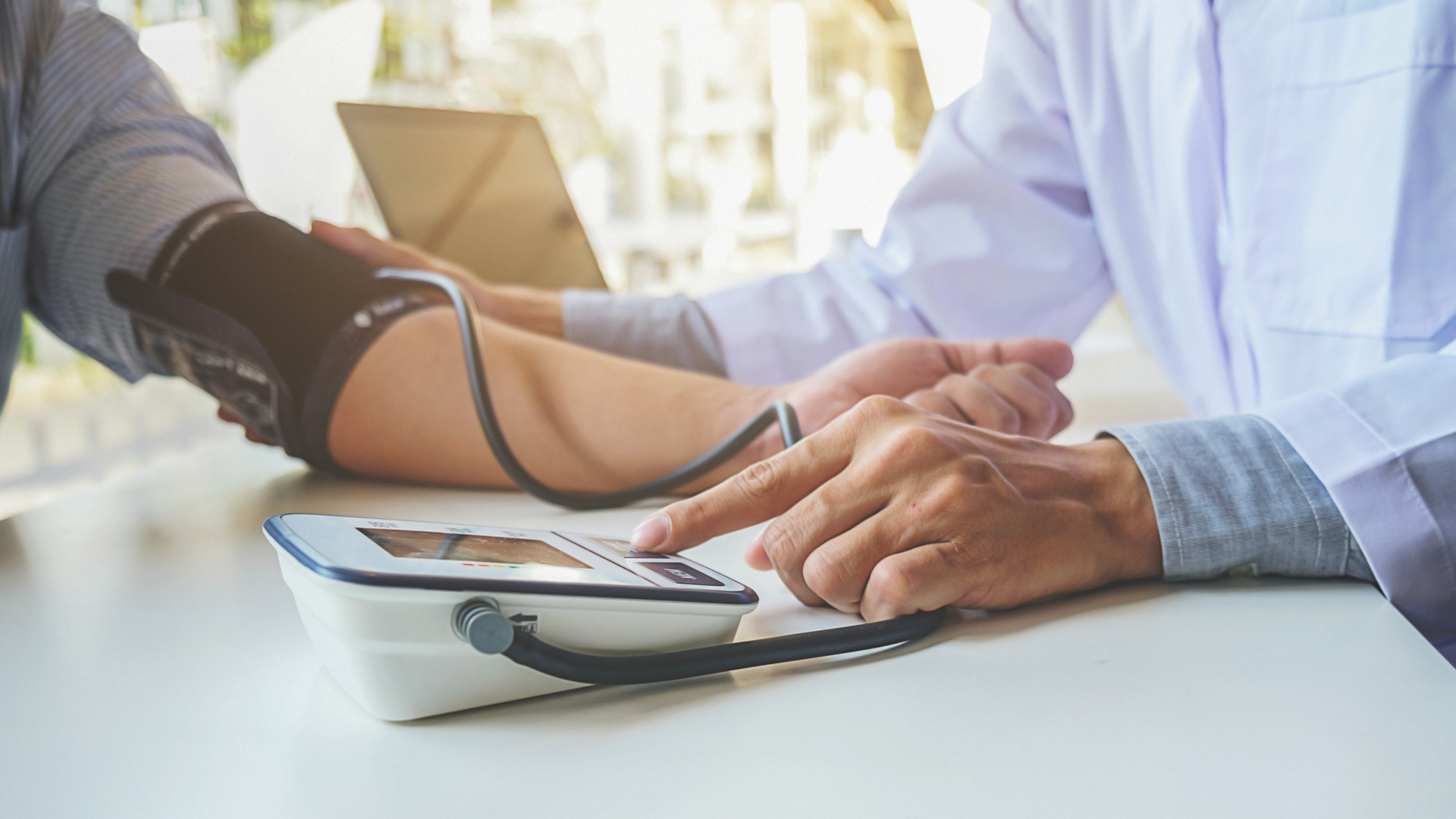 woman getting her blood pressure checked by a doctor
