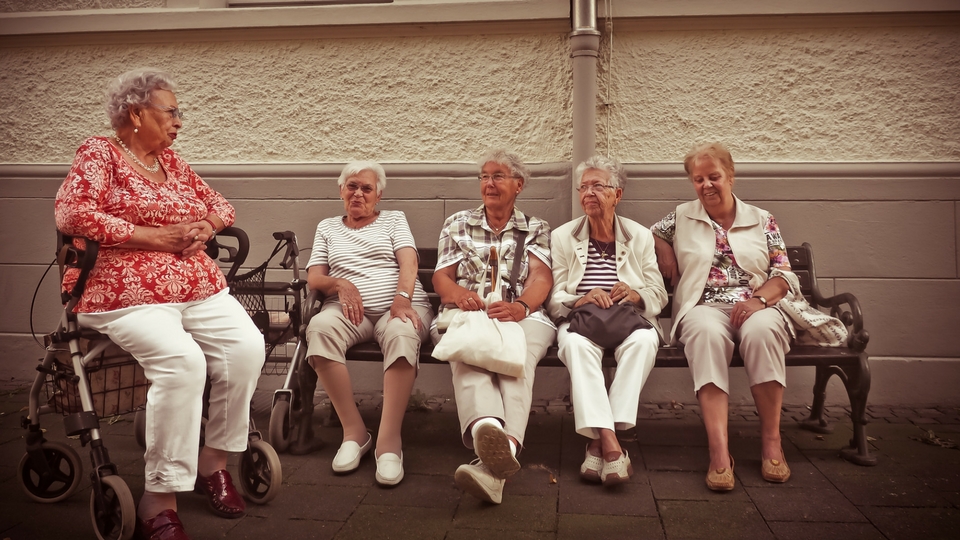 elderly women sitting on a bench