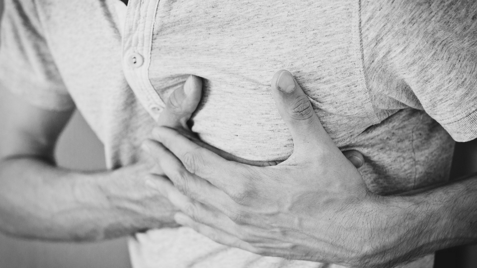 Man clutching his chest in pain