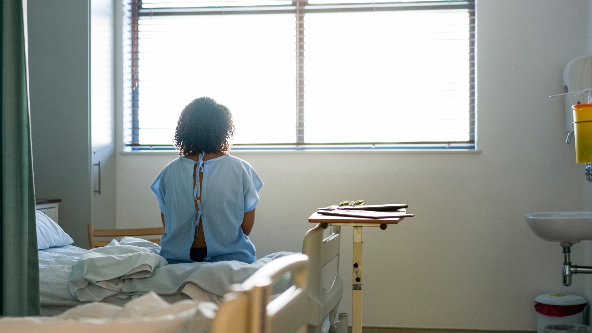 female hospital patient looking out the window