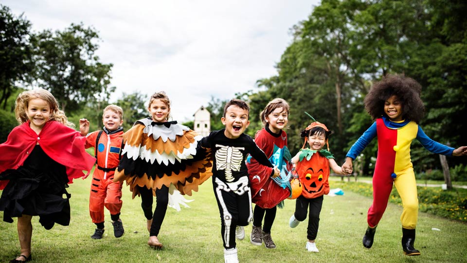 kids running in halloween costumes