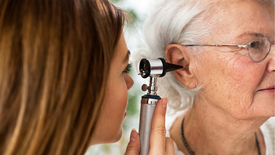 doctor looks in women's ear