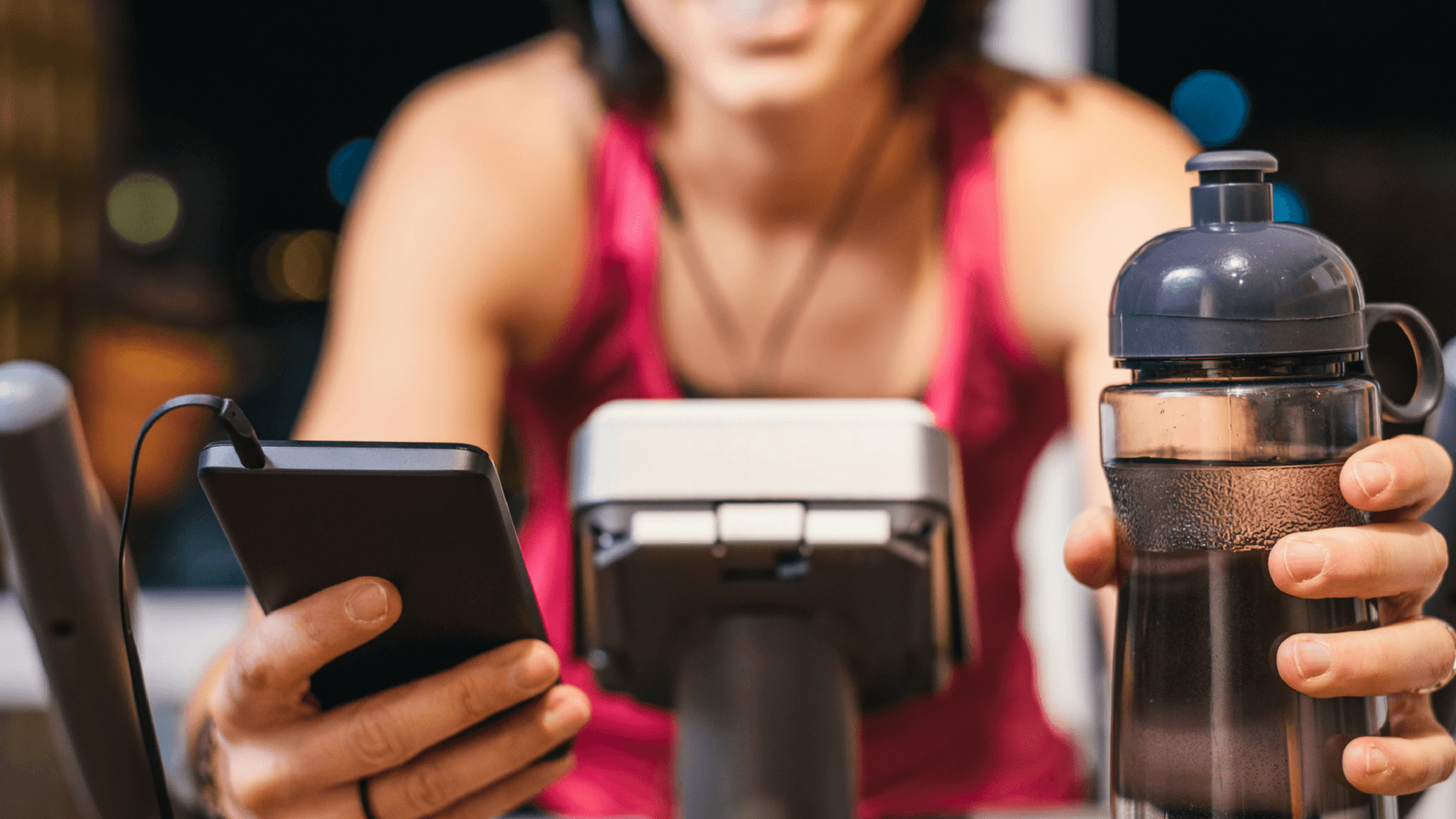 woman on a treadmill looking at her cellphone