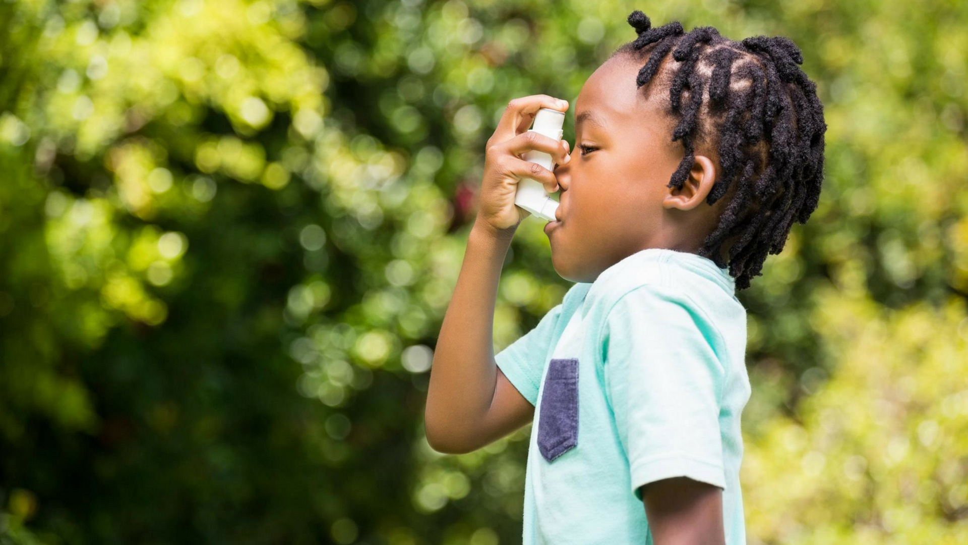 child using inhaler for asthma season