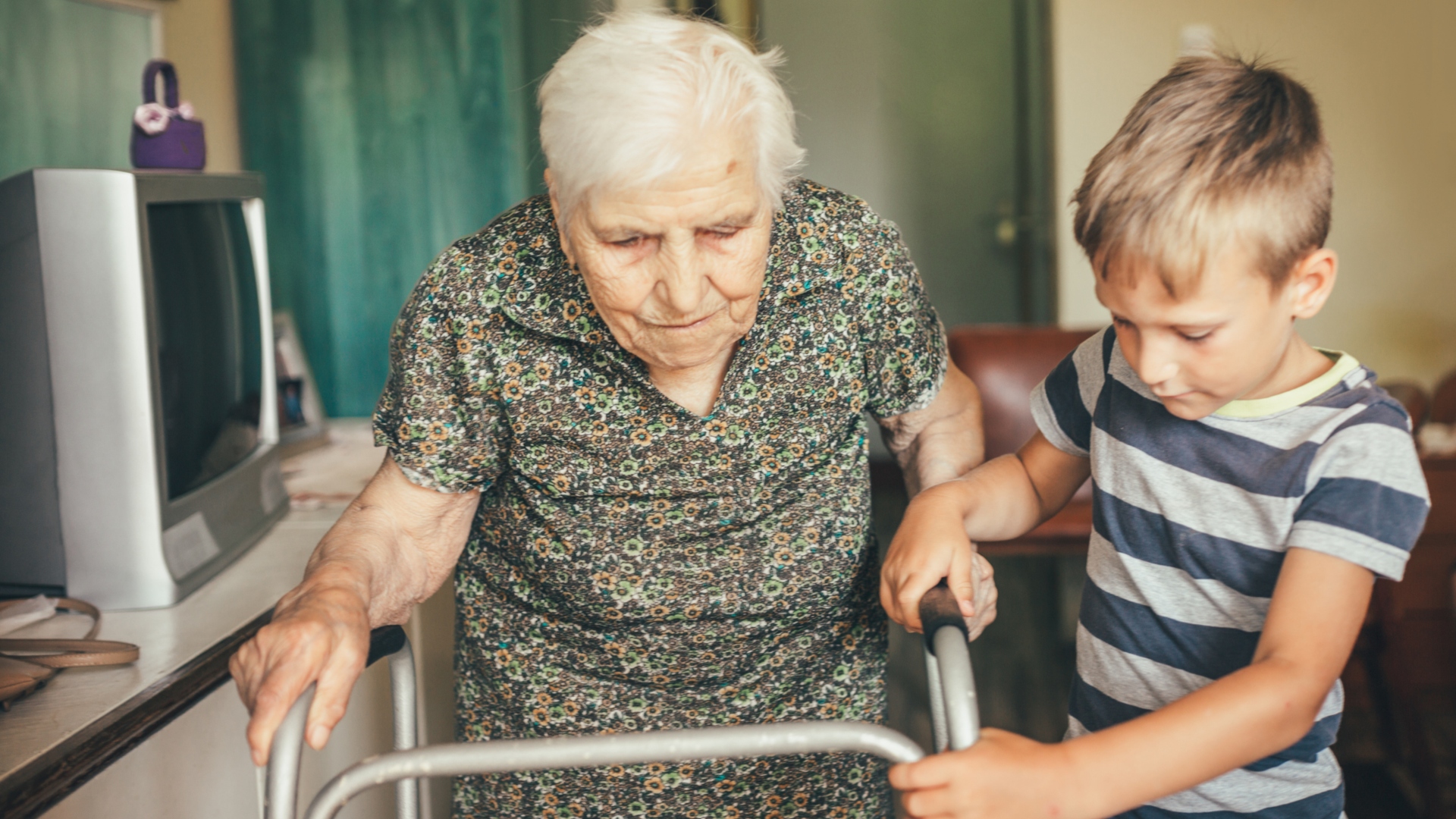 elderly woman walking with her grandson