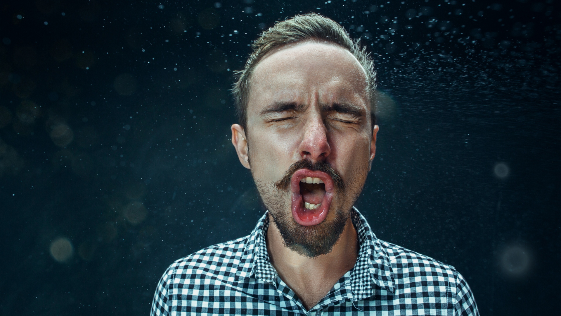 bearded man sneezing