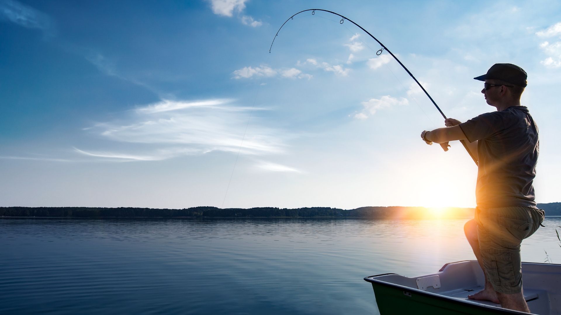 man fishing on lake