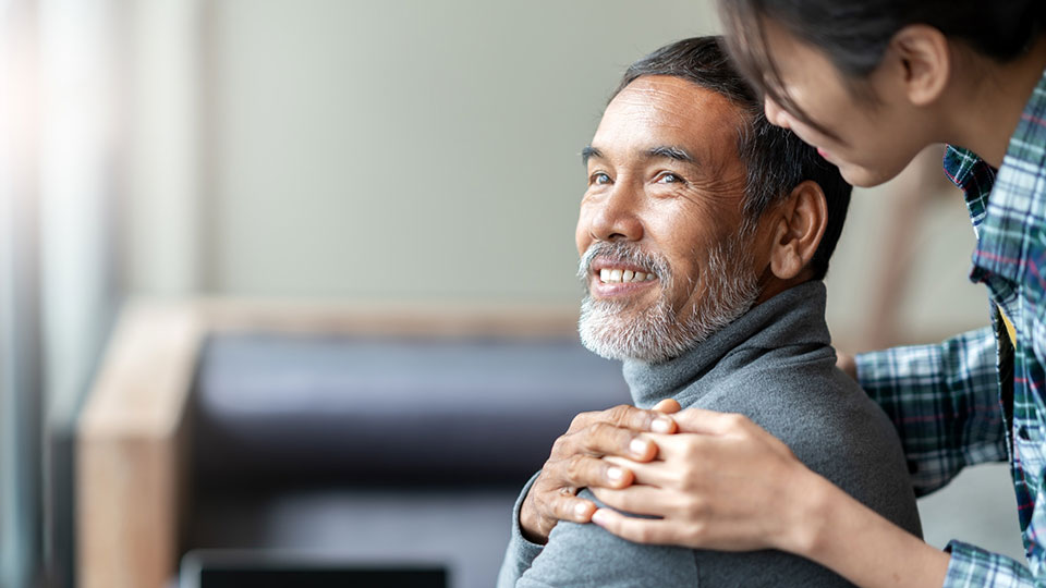 older man holding hands with his caretaker