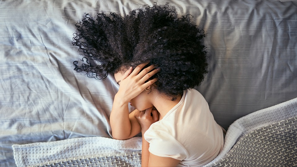 woman in bed with headache