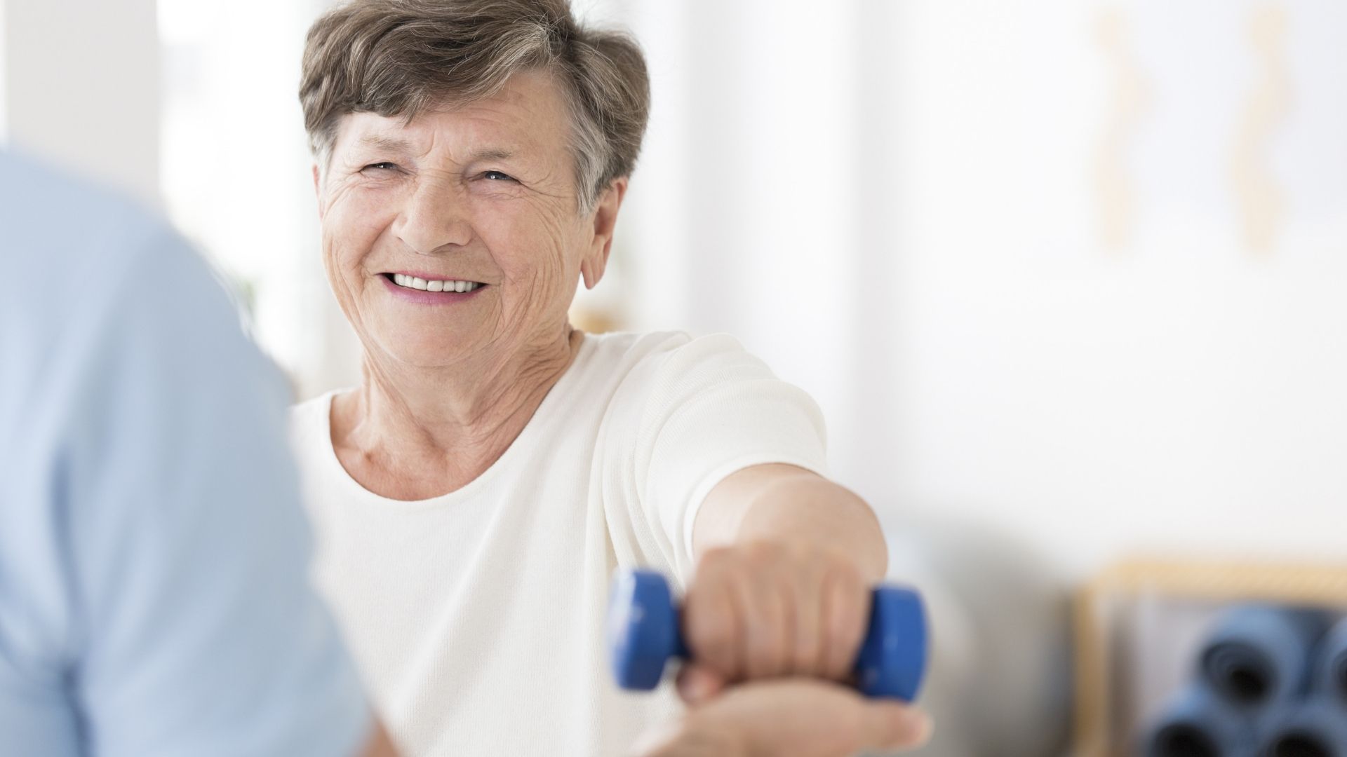 elderly woman exercising with hand weights