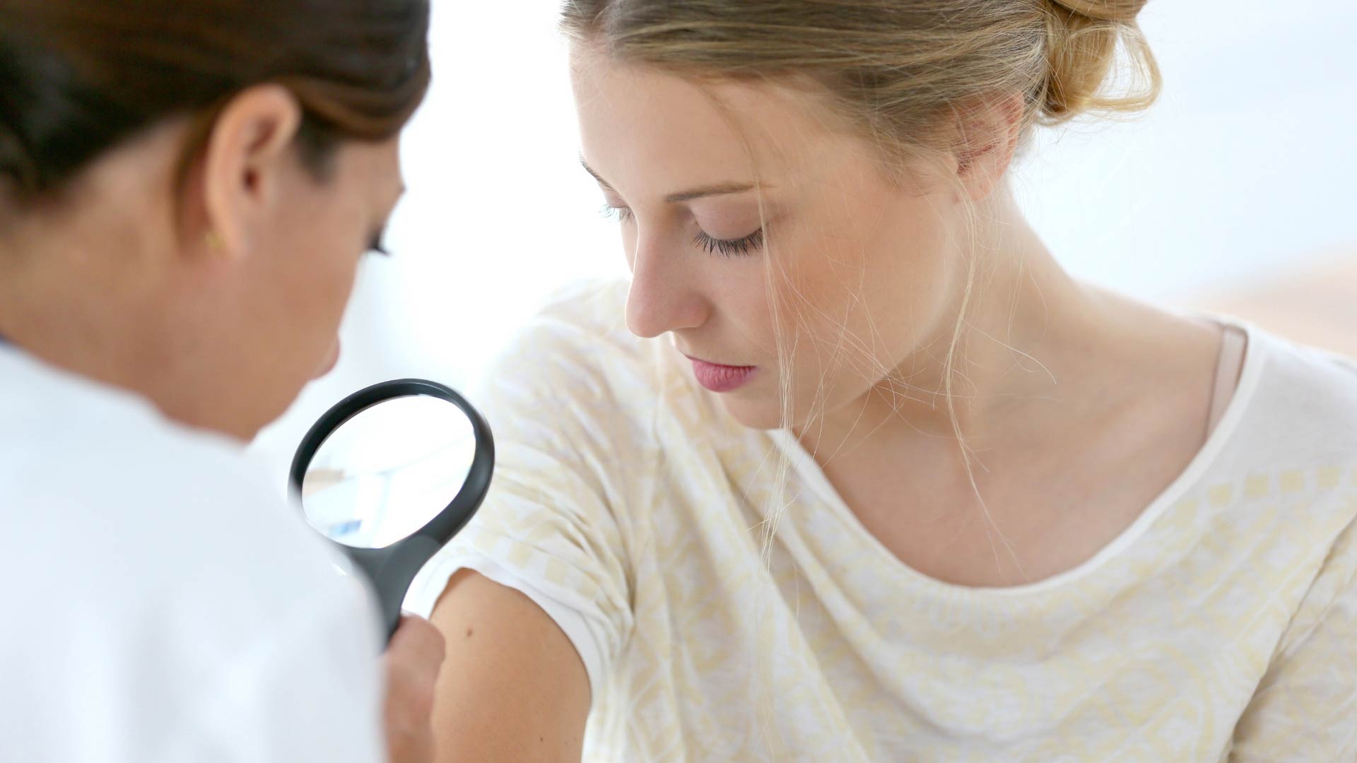 doctor examining a mole