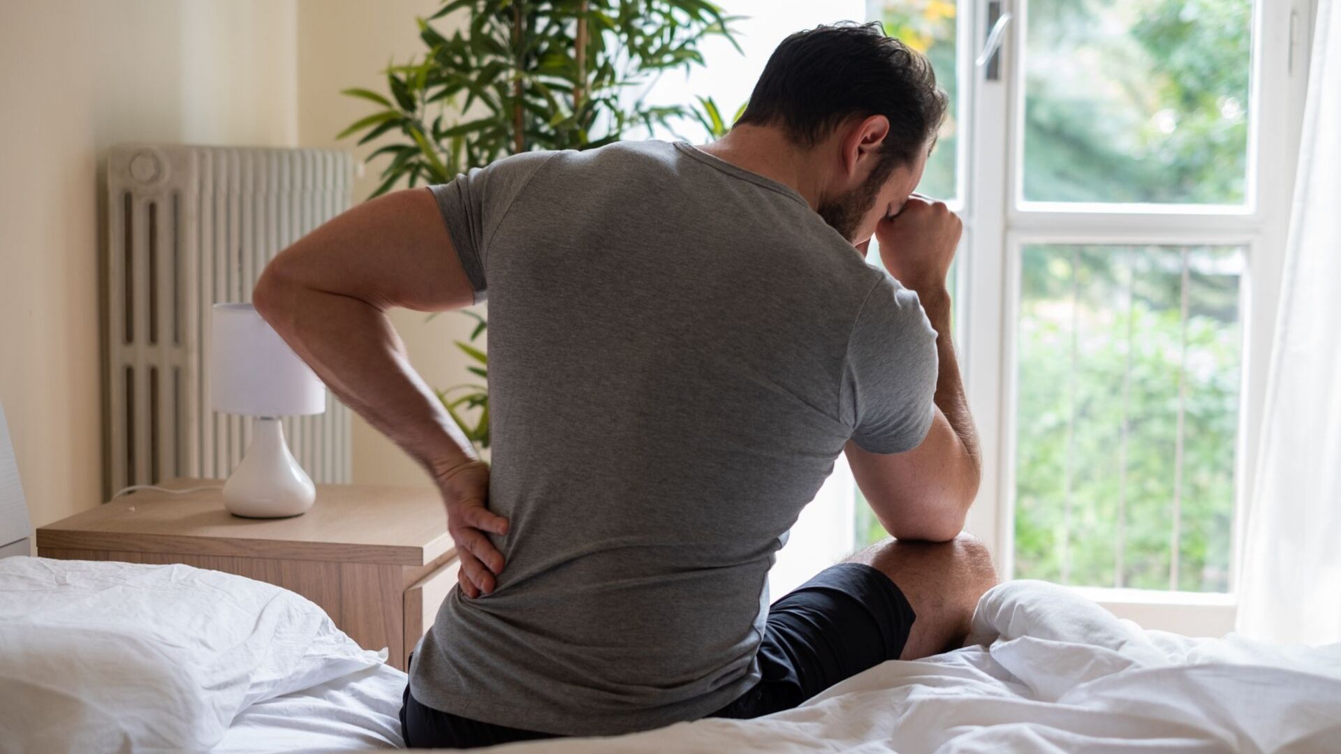 man holding his back in pain