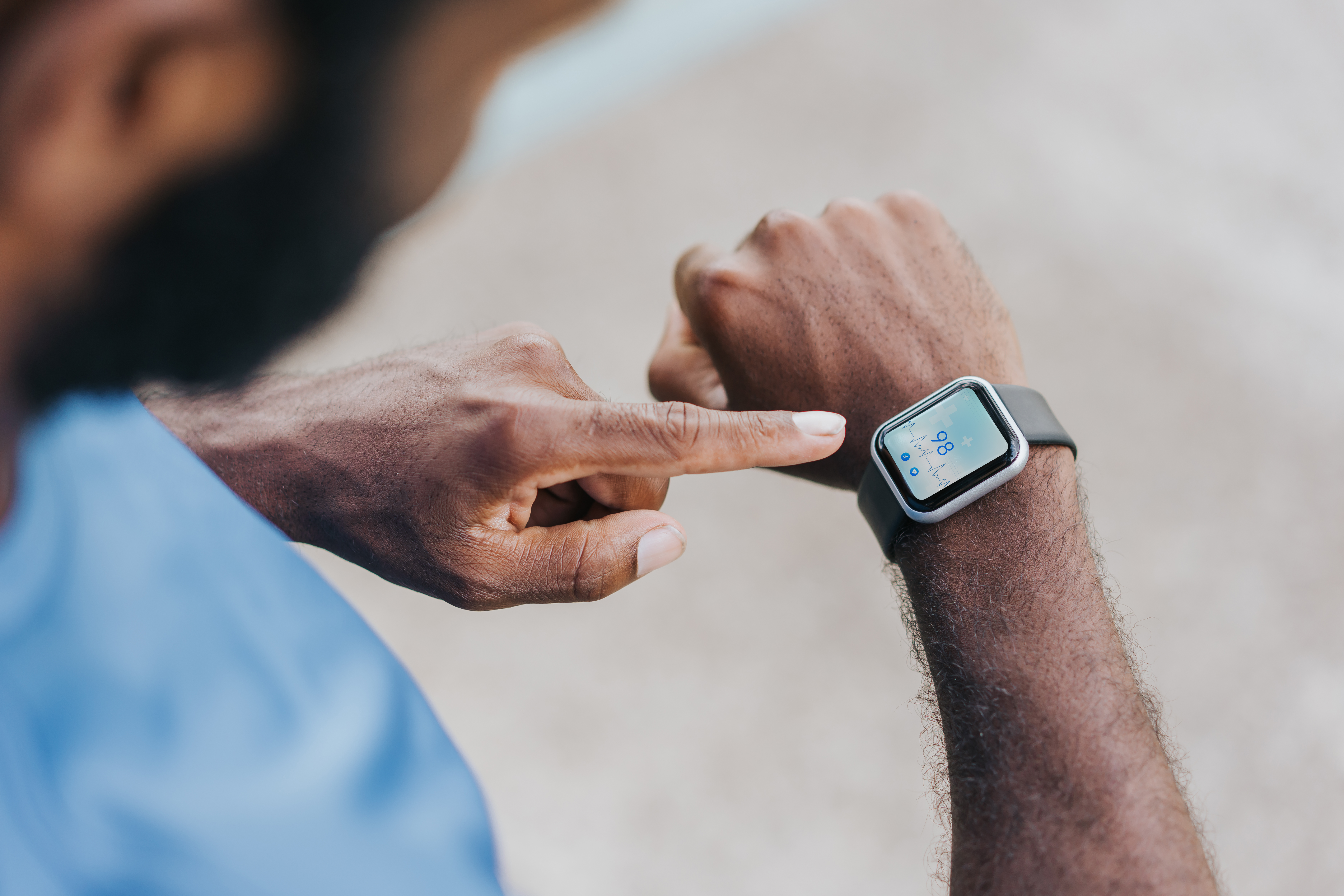 a man check his heart rate on his smart watch
