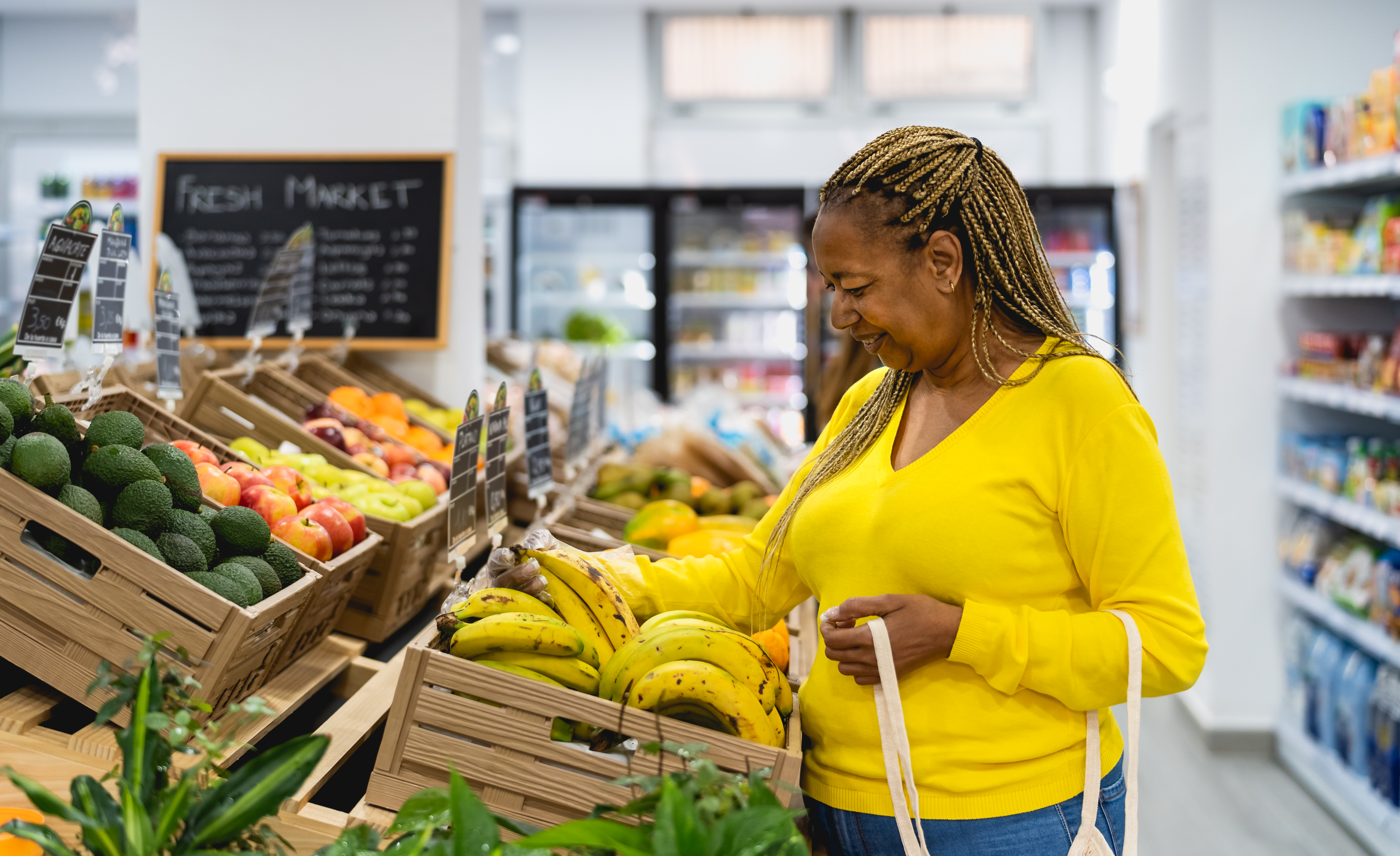 A woman browses the selection at a grocery store. 