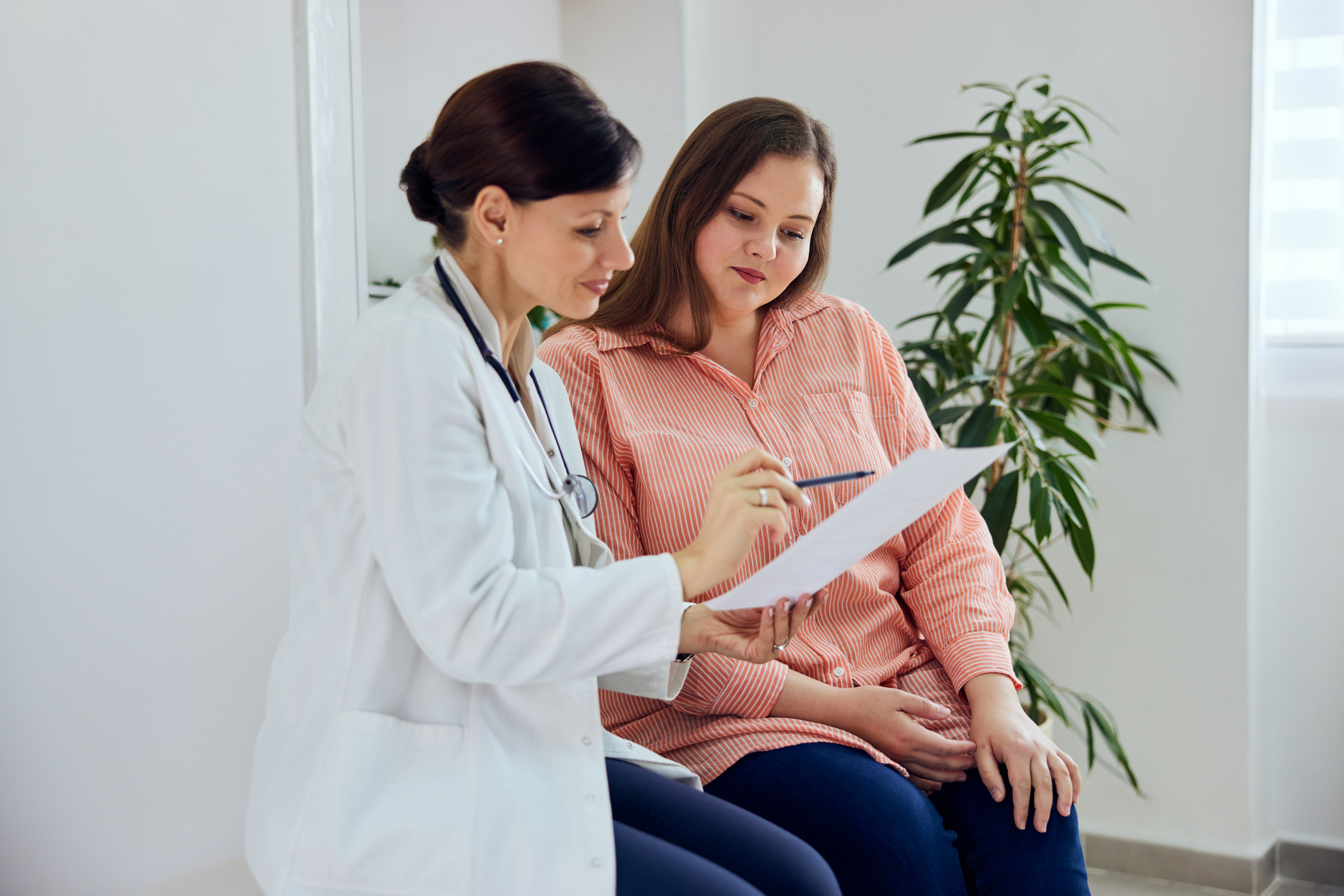 a woman discusses weight loss options with her doctor