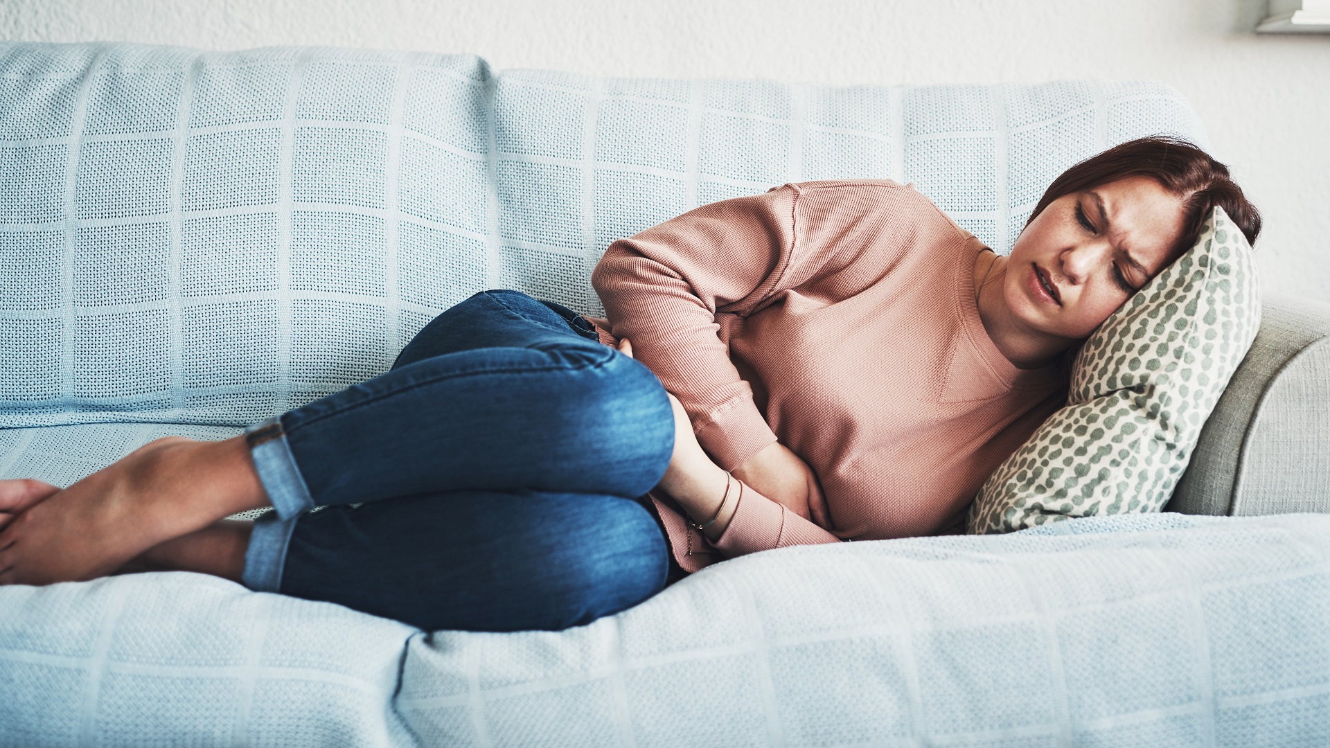Woman suffering stomach pain and nausea