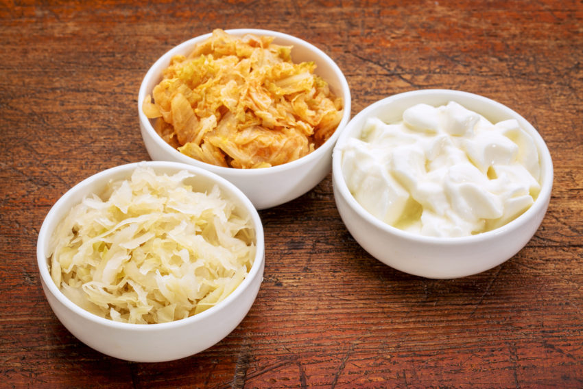 three bowls of fermented foods in white ceramic bowls