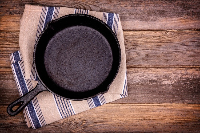 cast iron pan on wooden cutting board