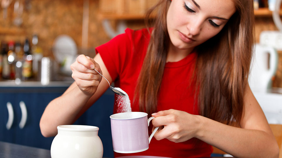 Woman Sweetening Coffee